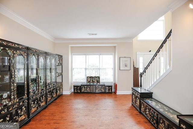 entryway featuring ornamental molding and hardwood / wood-style flooring