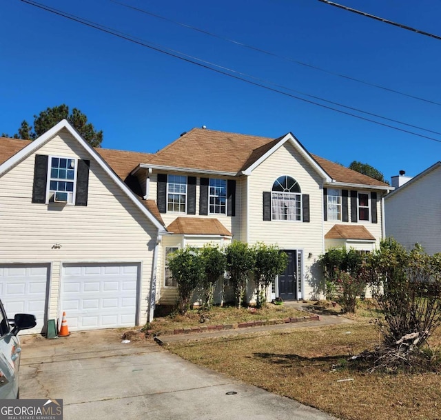 colonial home featuring cooling unit and a garage