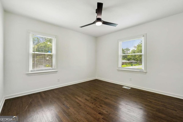 spare room featuring ceiling fan and dark wood-type flooring