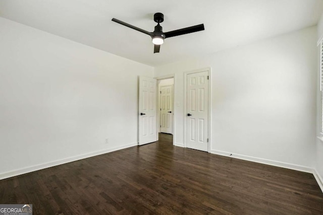 unfurnished bedroom with ceiling fan and dark hardwood / wood-style floors