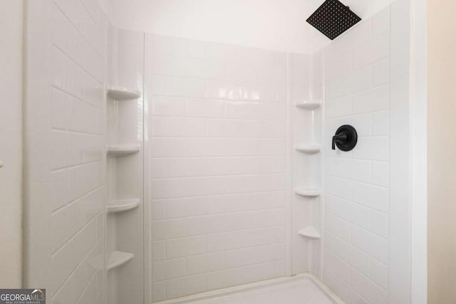 bathroom with a tile shower