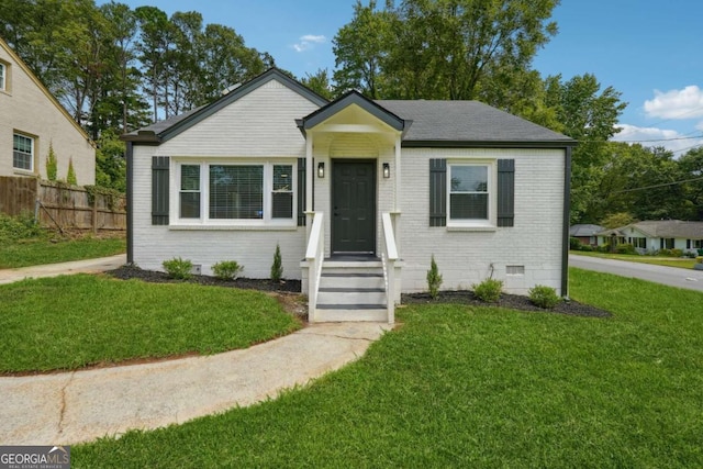 bungalow-style home featuring a front yard