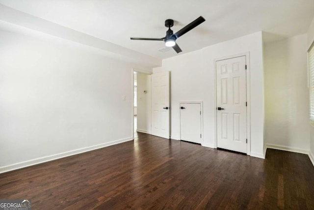 unfurnished bedroom with ceiling fan and dark hardwood / wood-style flooring