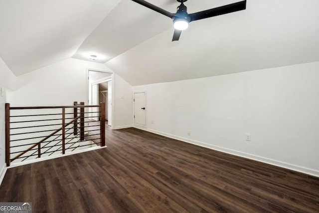 additional living space with lofted ceiling, dark hardwood / wood-style flooring, and ceiling fan