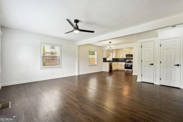 unfurnished living room with ceiling fan and dark wood-type flooring