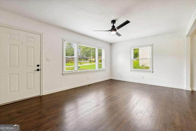 interior space with ceiling fan and dark wood-type flooring