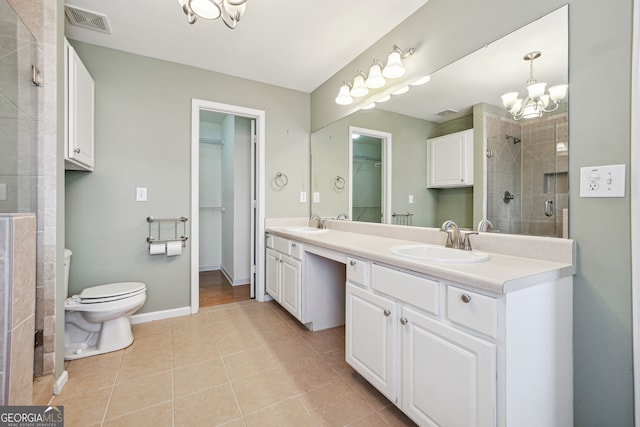 bathroom featuring vanity, tile patterned floors, walk in shower, a notable chandelier, and toilet