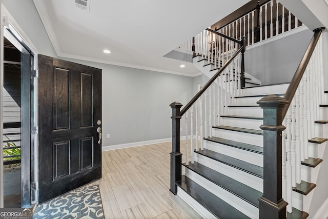 entryway featuring ornamental molding, visible vents, recessed lighting, stairway, and baseboards