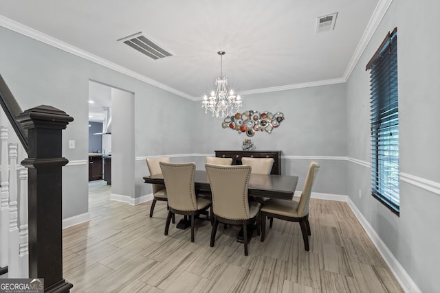 dining area with a chandelier, baseboards, ornamental molding, and visible vents