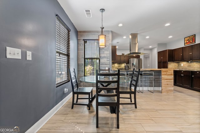 dining area featuring baseboards, visible vents, and recessed lighting