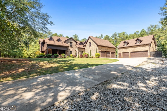 view of front of home featuring concrete driveway, a front yard, brick siding, and roof with shingles