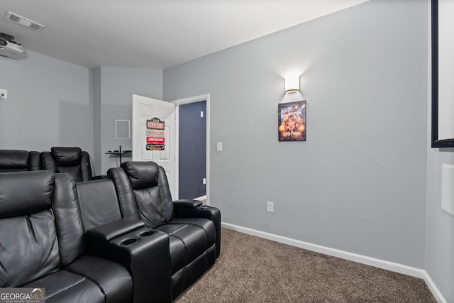 carpeted home theater featuring visible vents and baseboards