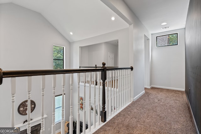 corridor with baseboards, recessed lighting, carpet floors, visible vents, and lofted ceiling