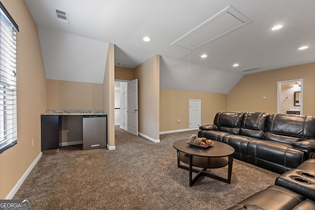 living room featuring visible vents, attic access, carpet flooring, and lofted ceiling