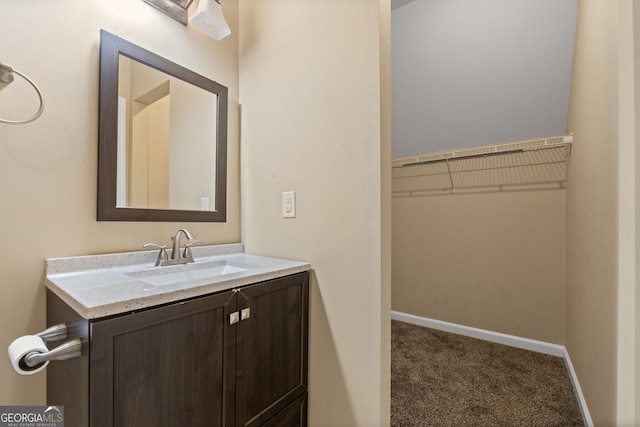 bathroom with baseboards and vanity