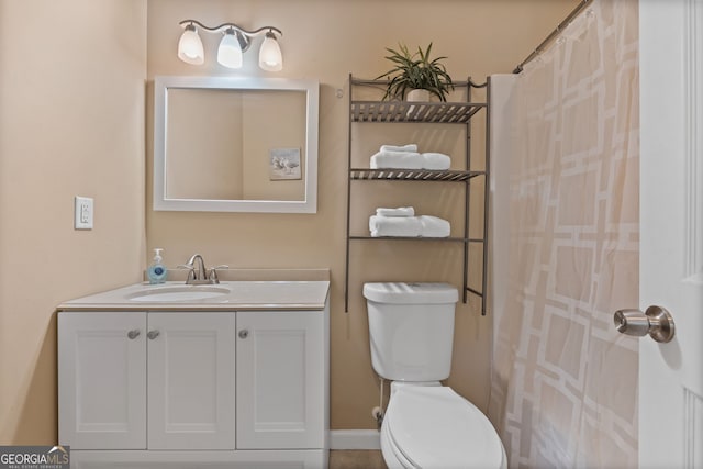 bathroom featuring vanity, toilet, and curtained shower