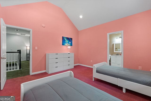 bedroom with light carpet, vaulted ceiling, ensuite bath, and sink