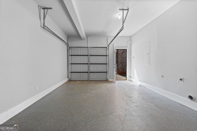 garage featuring baseboards and electric panel
