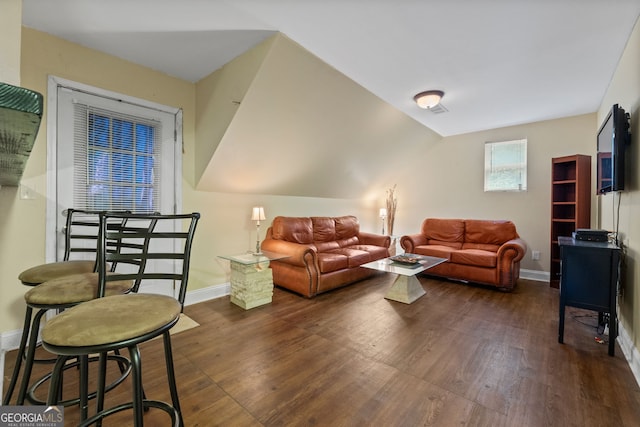 living room featuring lofted ceiling and dark wood-type flooring