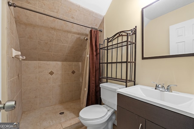 bathroom featuring tile patterned flooring, a shower with curtain, vanity, and toilet