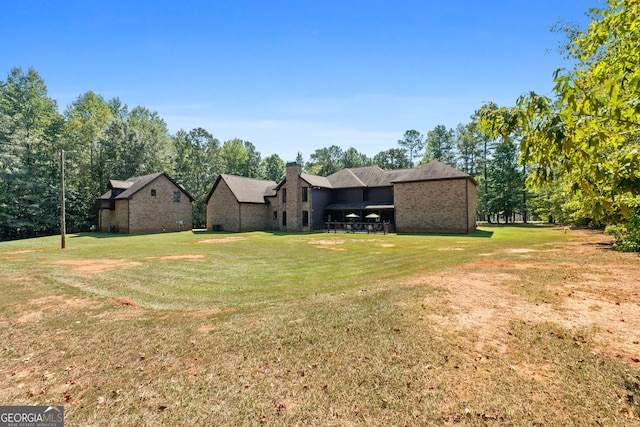 exterior space with a chimney and a front lawn