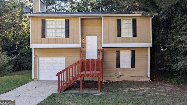 bi-level home with a front lawn and a garage