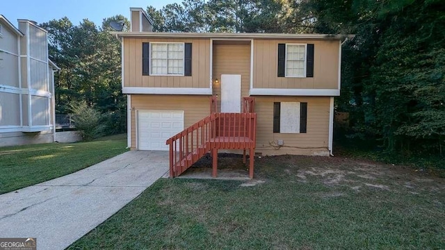 split foyer home with a garage and a front lawn