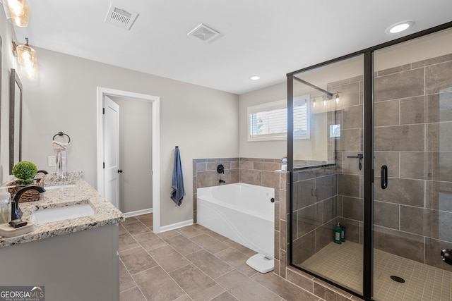 bathroom with vanity and separate shower and tub