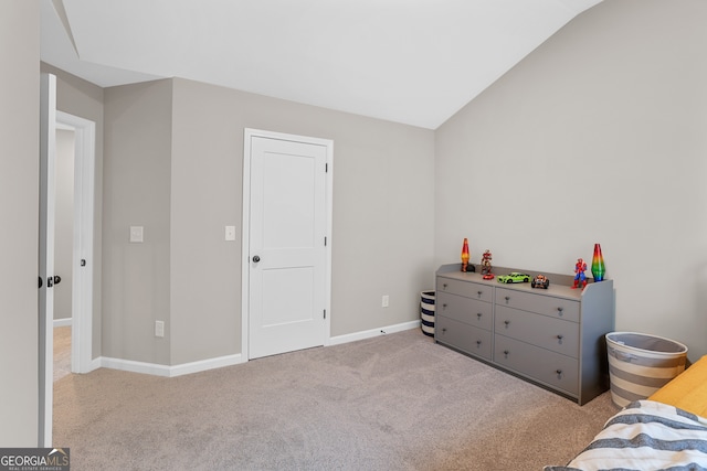 carpeted bedroom featuring lofted ceiling