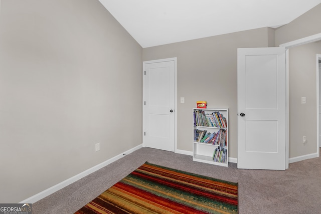 carpeted bedroom featuring lofted ceiling