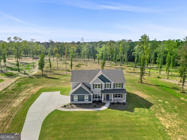 view of front of property with a rural view, a porch, and a front lawn