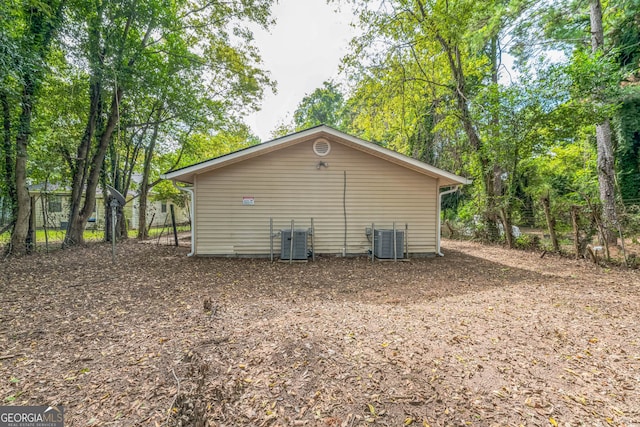 view of side of home with central air condition unit