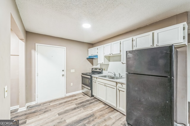 kitchen with stainless steel range with electric cooktop, sink, black refrigerator, and white cabinetry