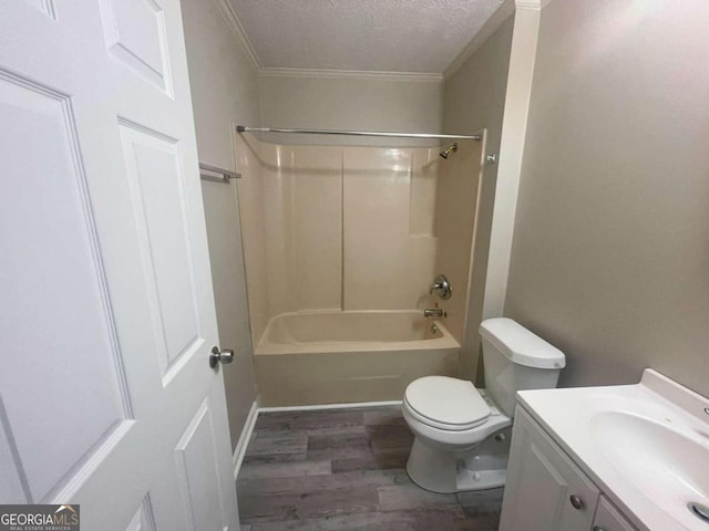 full bathroom with wood-type flooring, a textured ceiling,  shower combination, vanity, and toilet