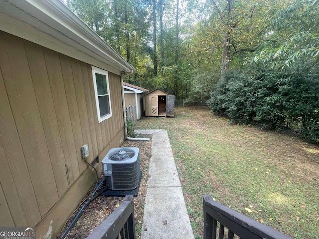 view of yard featuring cooling unit and a storage unit