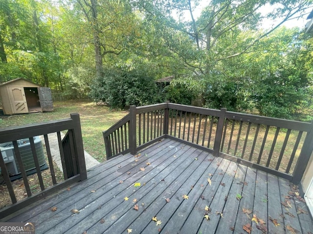 deck with a storage shed and central AC unit