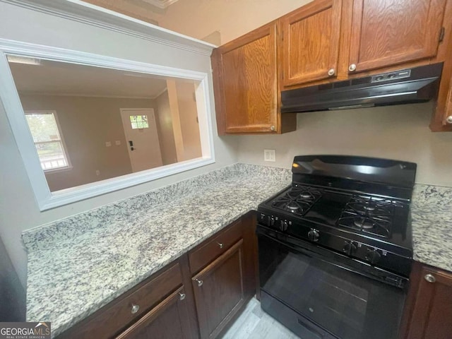 kitchen with light stone counters, black range with gas stovetop, and crown molding