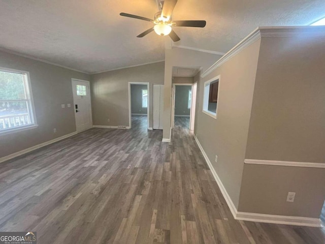 unfurnished living room featuring dark hardwood / wood-style flooring, a textured ceiling, ceiling fan, and crown molding