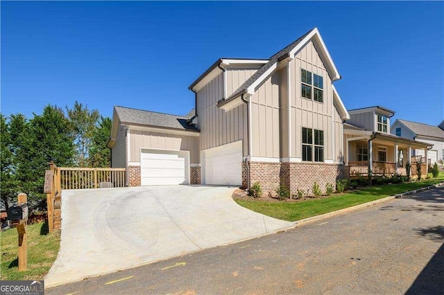 view of front of property with covered porch and a garage