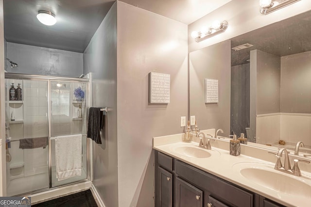 bathroom with vanity and a shower with door