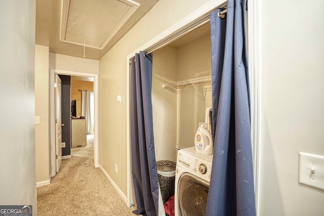 interior space featuring washer / clothes dryer and light colored carpet