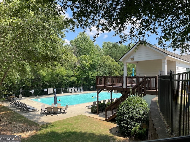 view of pool featuring a wooden deck and a patio area