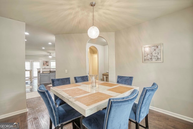 dining area featuring ceiling fan and dark wood-type flooring