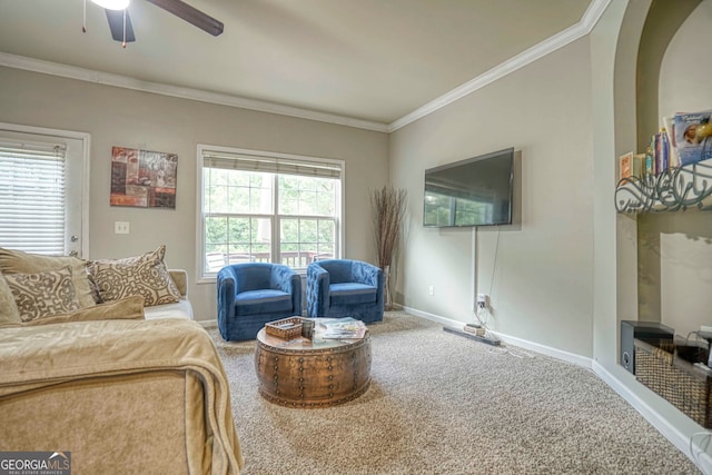 carpeted living room featuring crown molding and ceiling fan