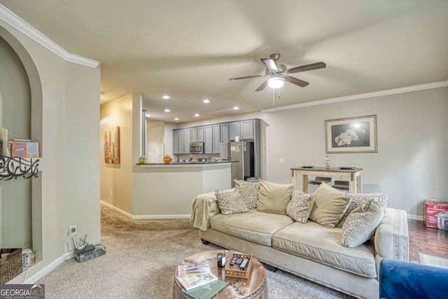 carpeted living room with ceiling fan and crown molding