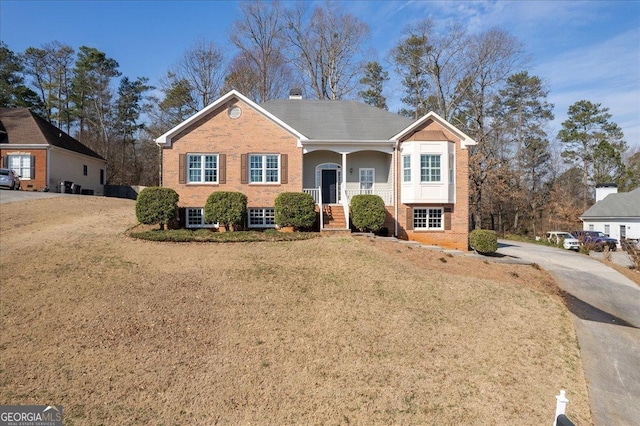 view of front of property with brick siding and a front yard