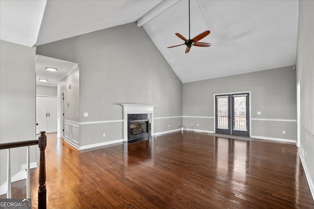 unfurnished living room featuring high vaulted ceiling, beamed ceiling, a fireplace, and wood finished floors