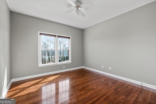 unfurnished room featuring ceiling fan, baseboards, and wood finished floors