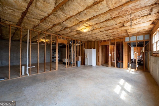 miscellaneous room with unfinished concrete flooring