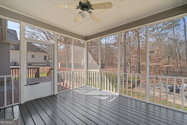 unfurnished sunroom with ceiling fan and a wealth of natural light